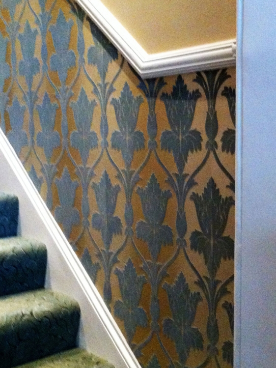 Wallpapering throughout, woodwork, cornices and friezes.