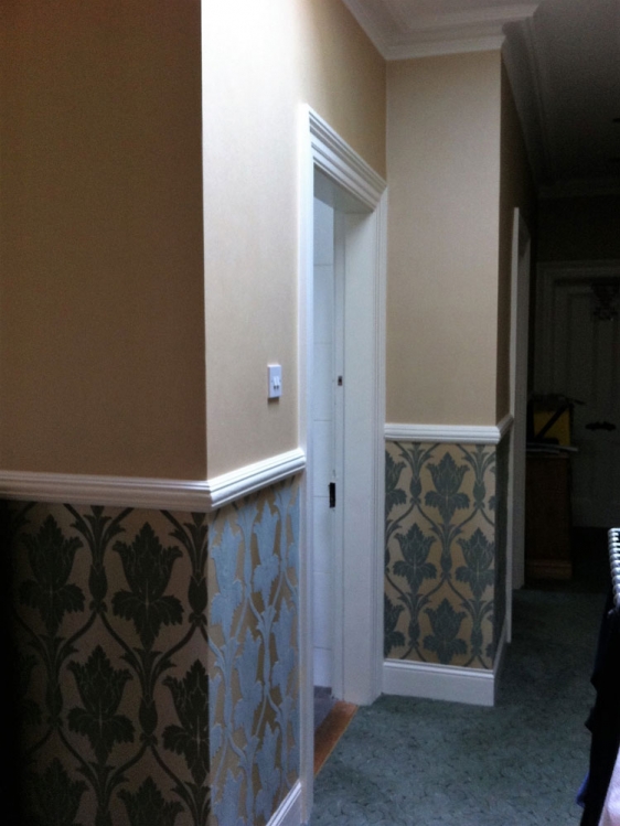 Wallpapering throughout, woodwork, cornices and friezes.