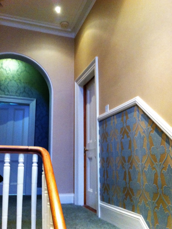 Wallpapering throughout, woodwork, cornices and friezes.