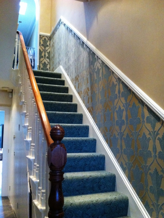 Wallpapering throughout, woodwork, cornices and friezes.